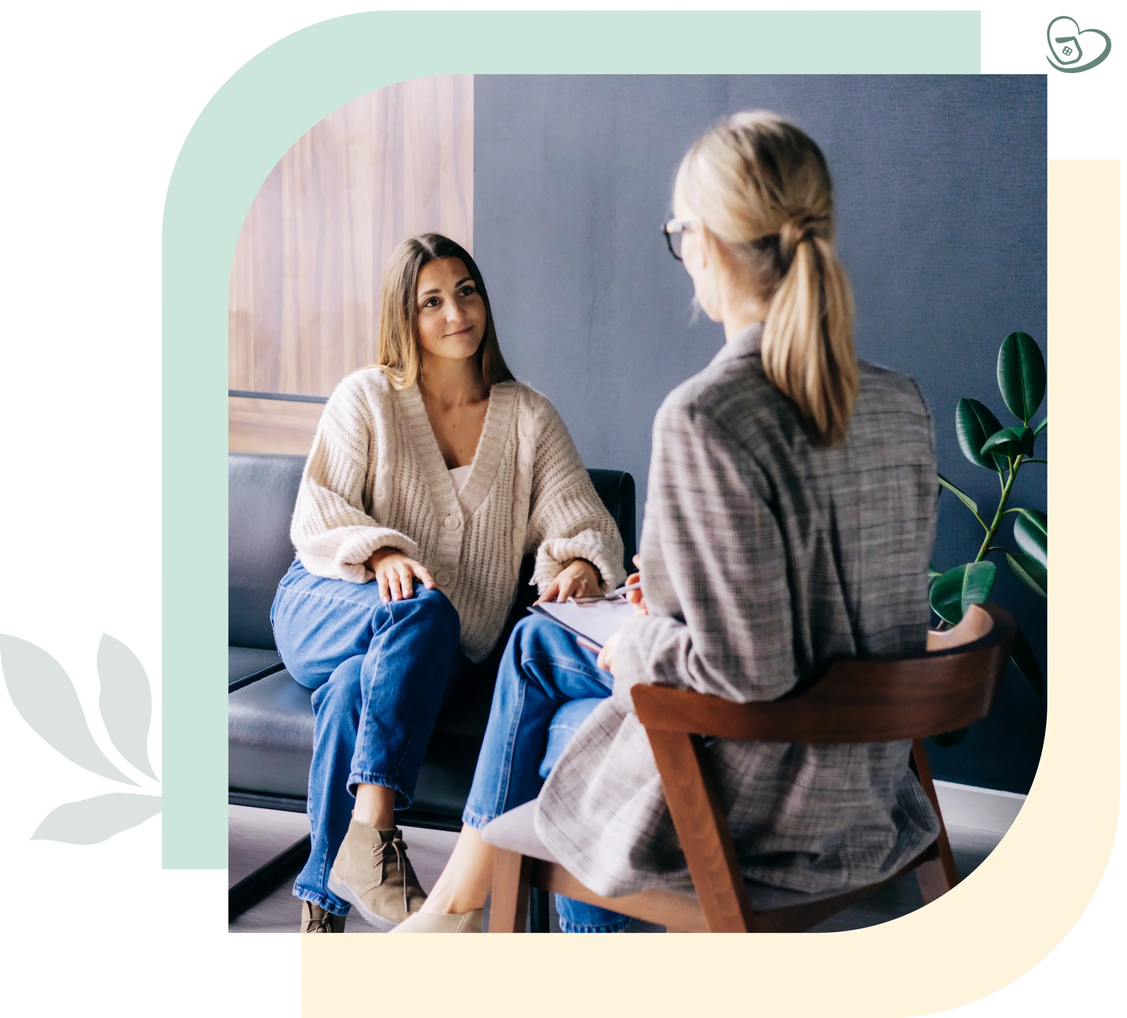 Two women sitting and talking in office.