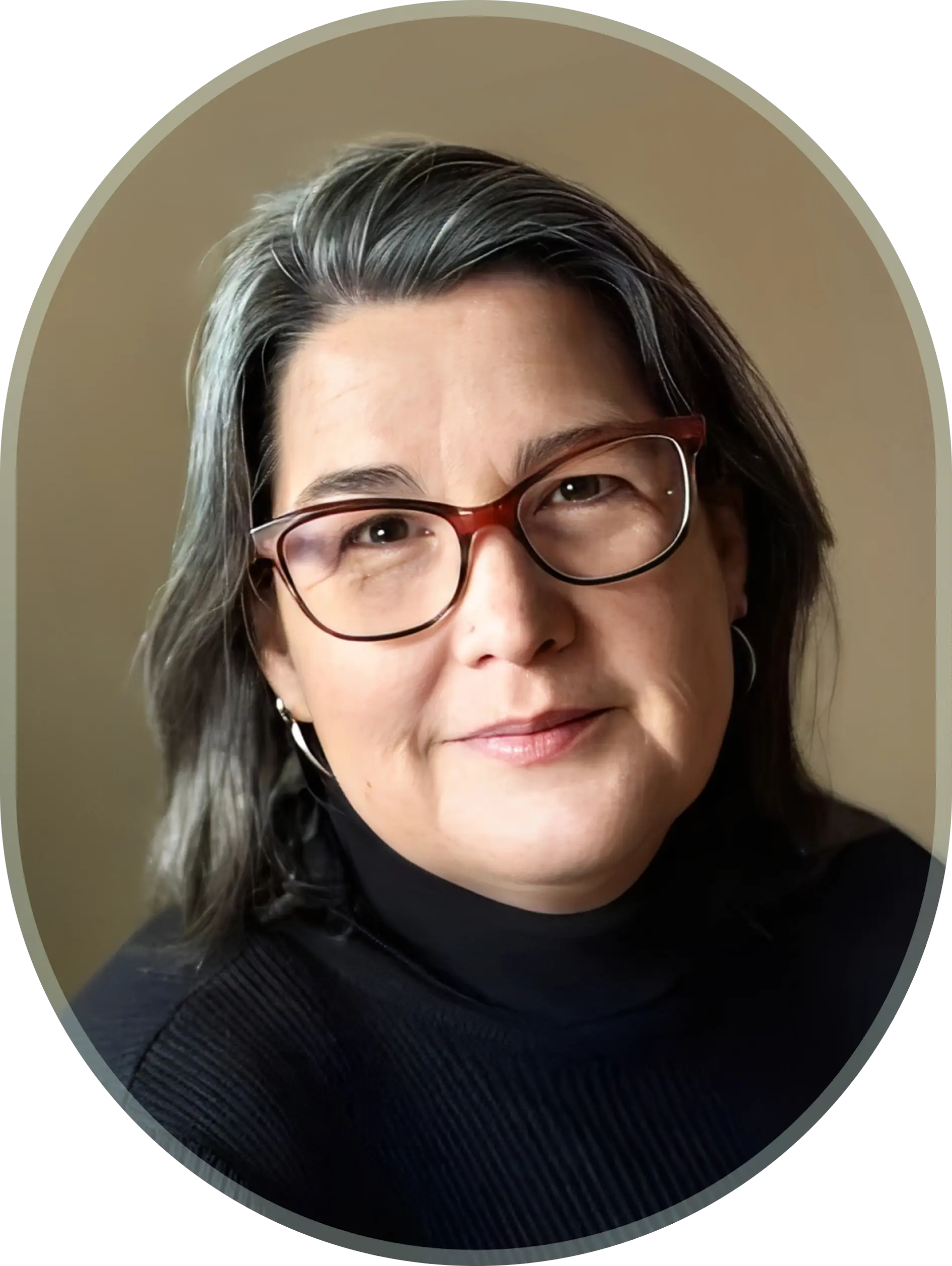 Woman with glasses and gray hair smiling.